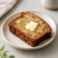 Illustrative image of a slice of banana bread on a plate
