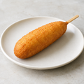 Illustrative image of a battered sausage on a stick, like a corn dog