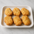 Illustrative image of six crispy chicken nuggets